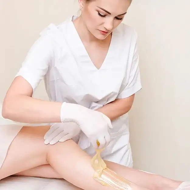 cosmetologist-beautician-waxing-female-legs-in-the-spa-center