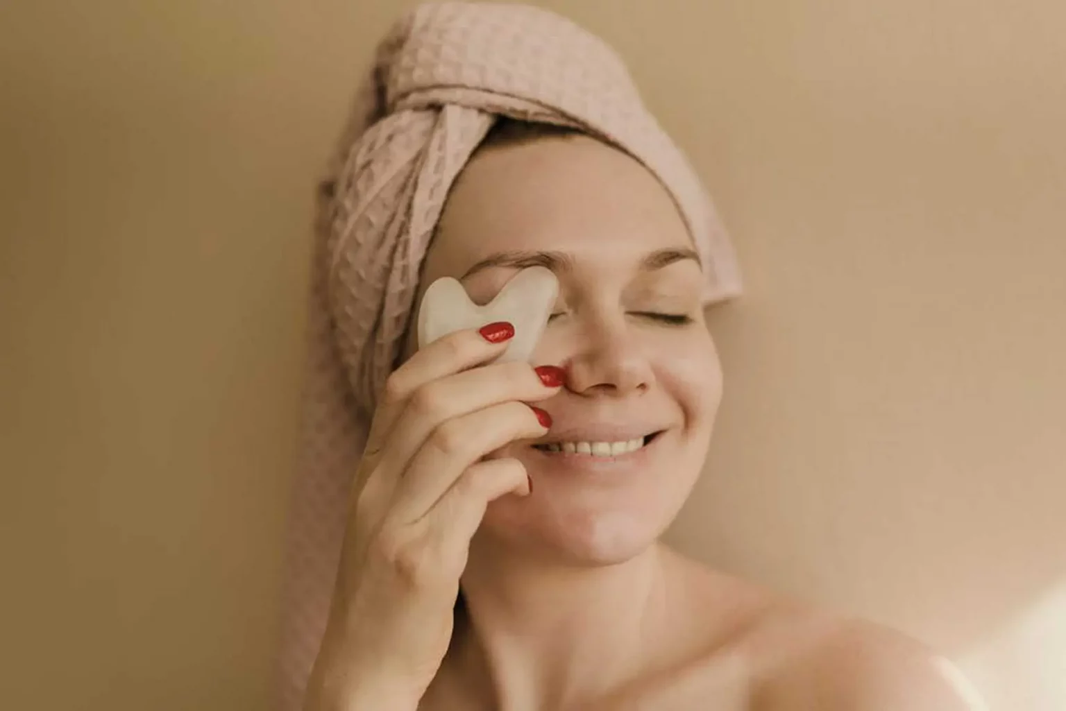 woman-holding-object-against-her-face-with-eyes-closed img